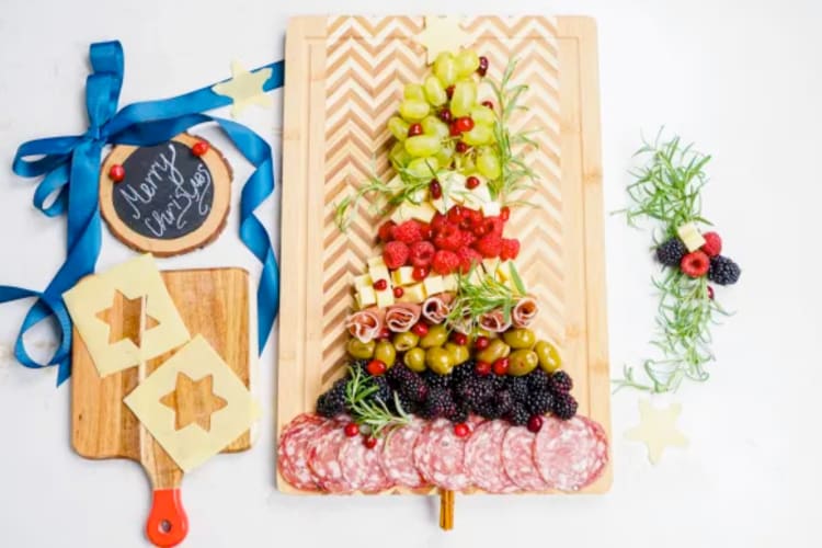 A festive charcuterie board shaped like a Christmas tree
