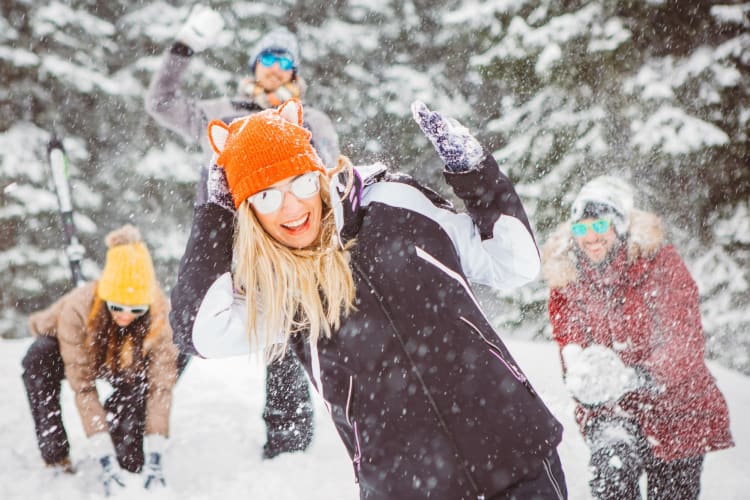 Four people having a snowball fight 
