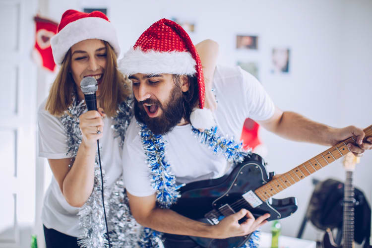 A couple singing karaoke on Christmas