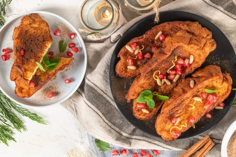 A French toast type dish with pomegranate seeds and pine nuts