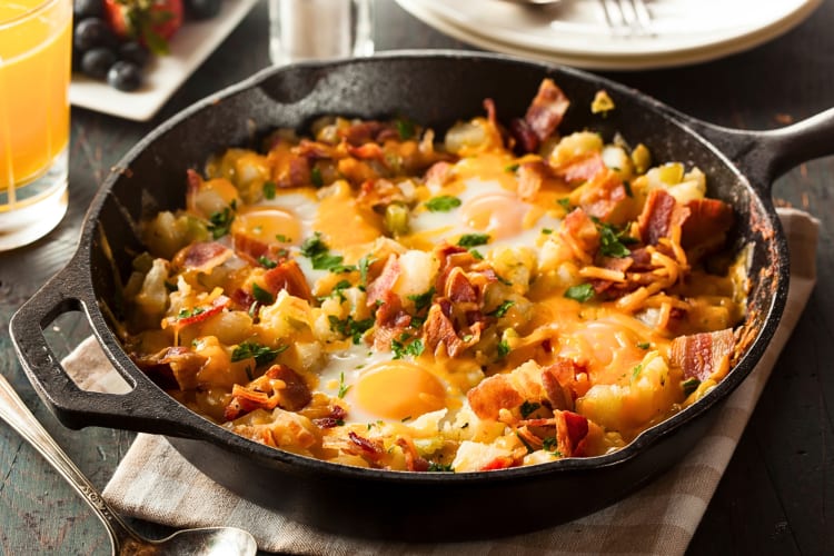 Breakfast meal in a pan with potatoes, eggs and bacon