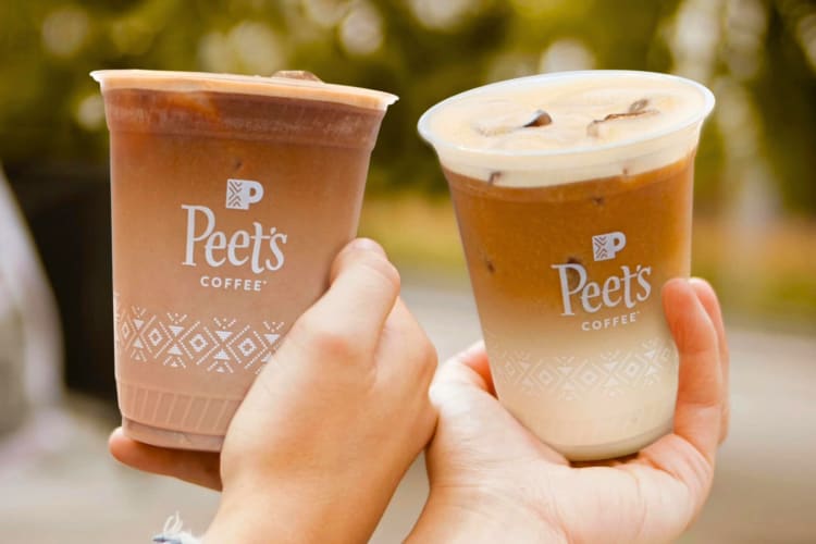 People holding iced coffee with Peet's Coffee labels