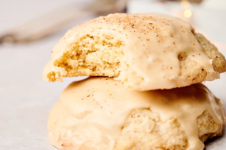 Two cookies with frosting stacked on top of each other