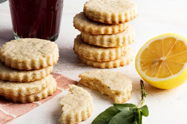 Lemon shortbread cookies next to half a lemon
