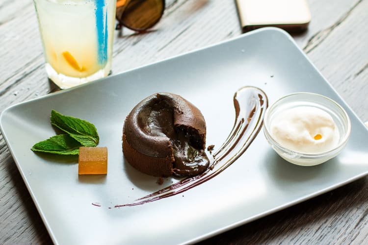 Coulant de chocolate on a plate with a bowl of ice cream