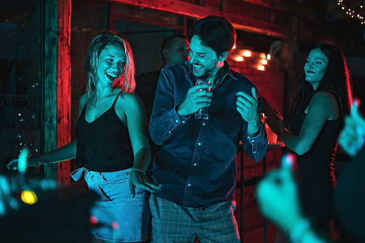 A couple dancing together in a club during a date night idea in OKC