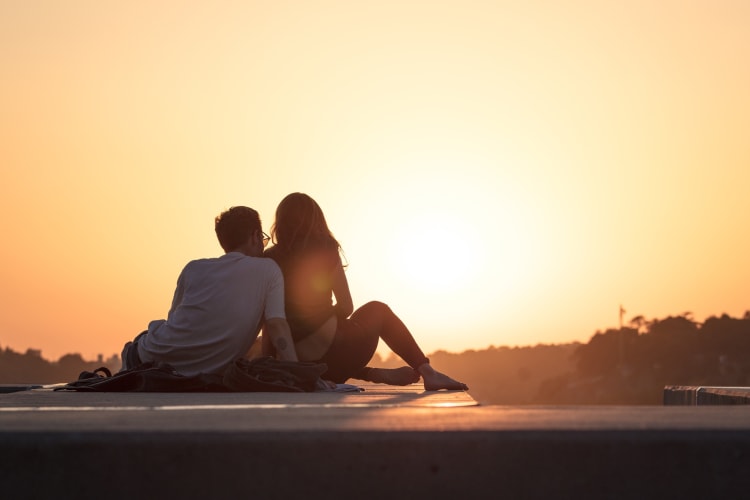 Couple sitting and watching the sunset