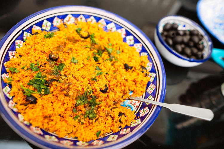 A blue patterned bowl with couscous