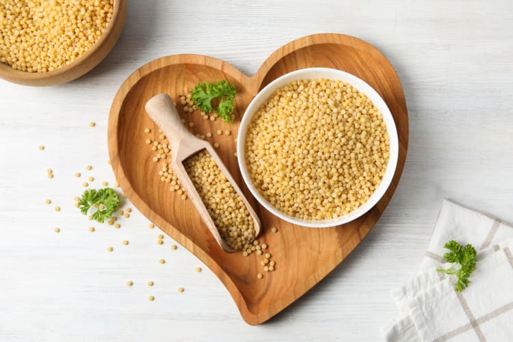 Peal couscous on a heart-shaped board