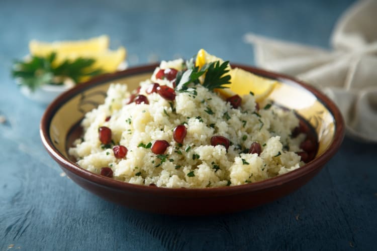 A bowl of couscous with pomegranate, lemon and herbs