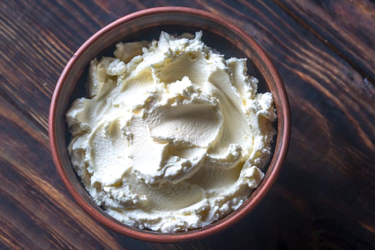 Aerial view of cream cheese in a brown bowl