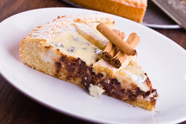 Crostata ricotta e visciole topped with cinnamon sticks