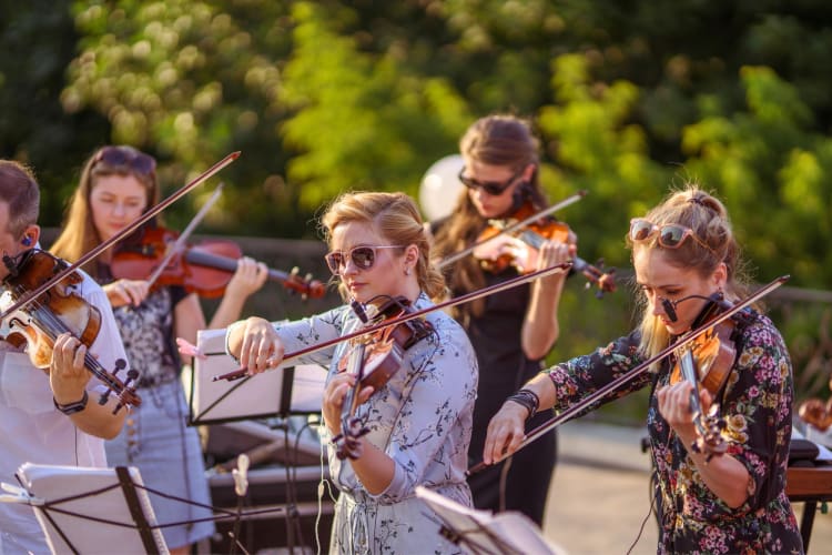 An orchestra performing outdoors