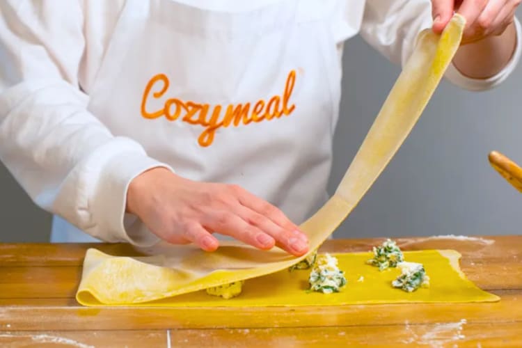 A chef making fresh pasta filled with spinach and ricotta