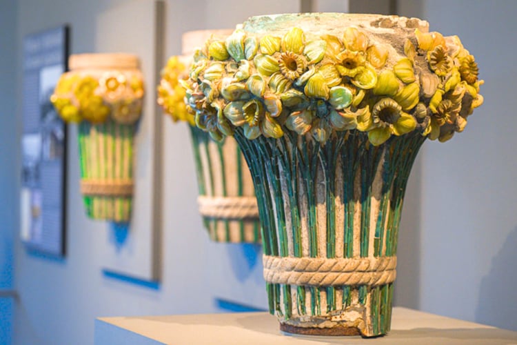 A glass sculpture of flowers in a museum