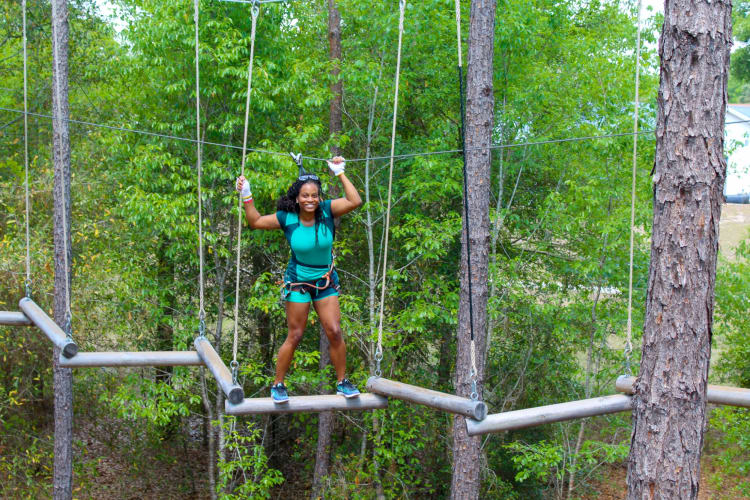 A woman on a tree top obstacle course