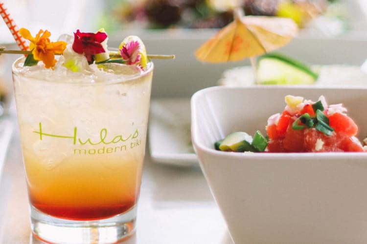 A cocktail in a glass that says Hula's Modern Tiki