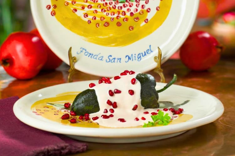 A chile rellano dish with pomegranate seeds