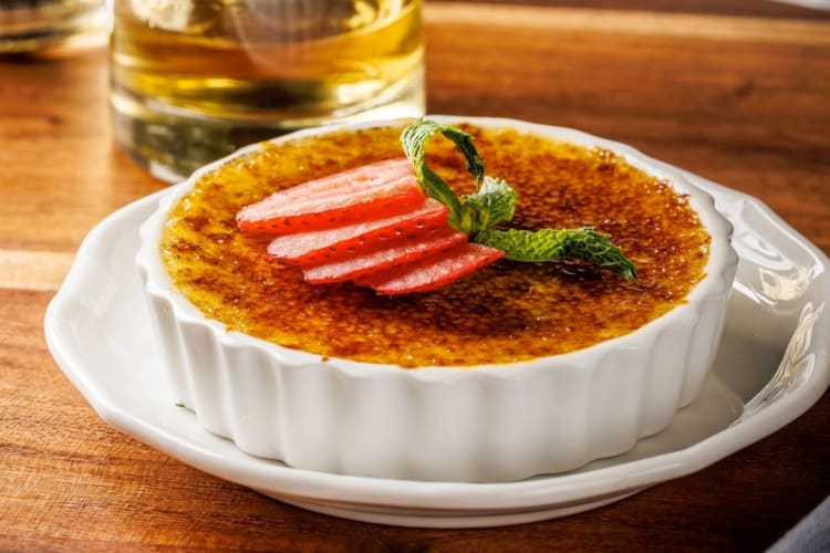 A crème brûlée with strawberries on top