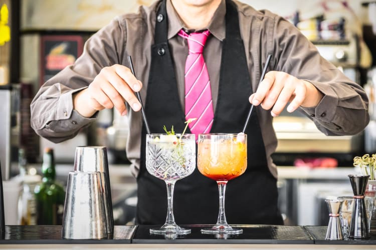 A bartender mixing some cocktails