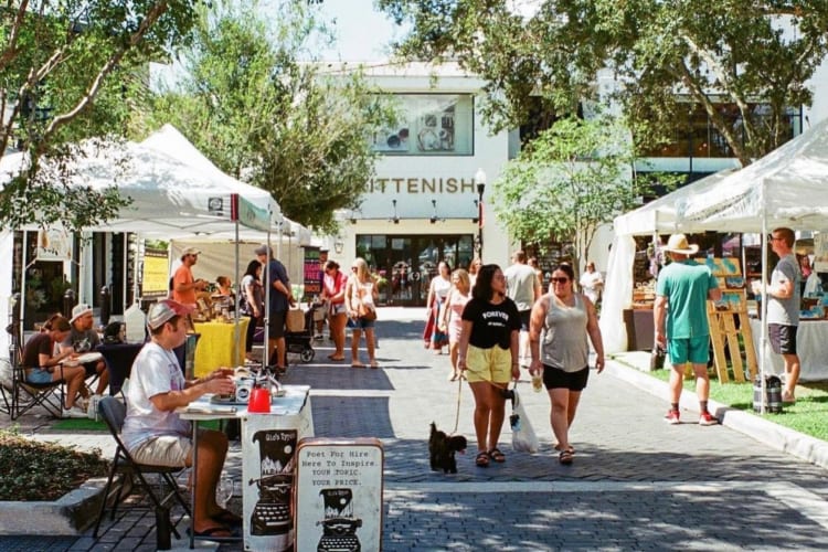 People walking around and shopping at an outdoor shopping mall