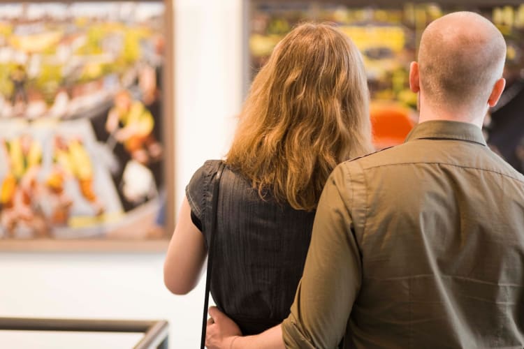 People admiring art at a museum