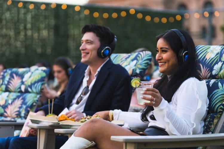 A couple watching a movie at an outdoor theater