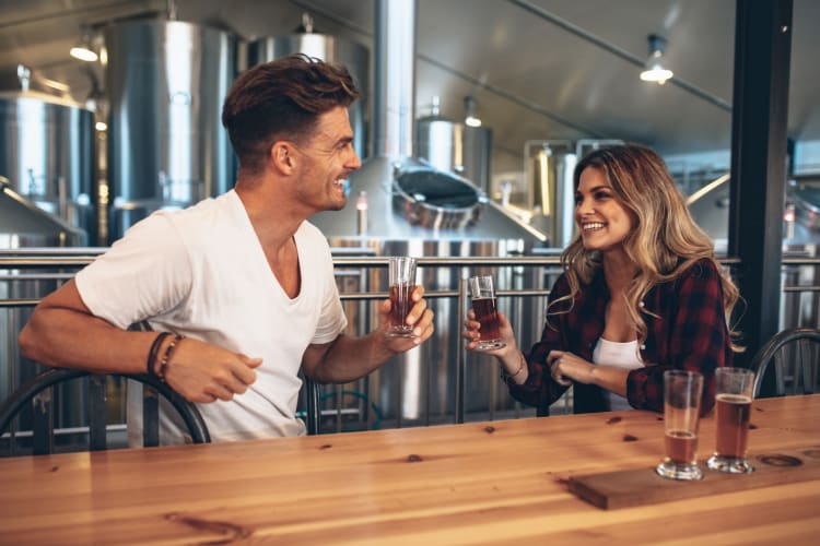 A couple having beer at a brewery 