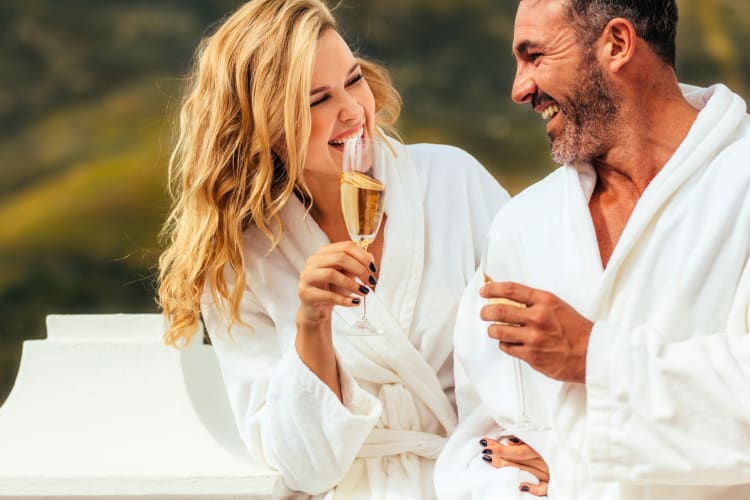 A couple in spa bathrobes with champagne