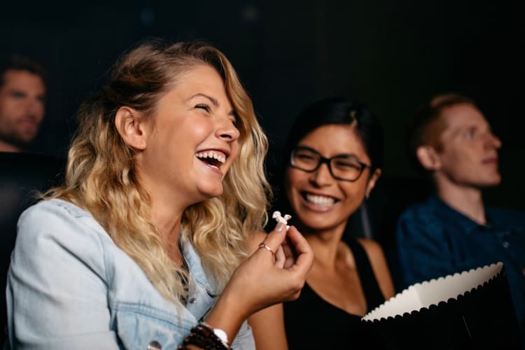 People laughing at a show in a theater