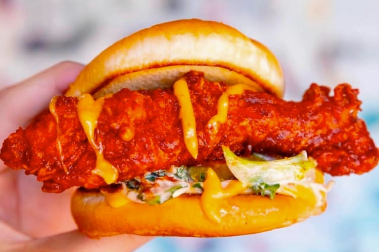 An extra spicy chicken sandwich with slaw and sauce