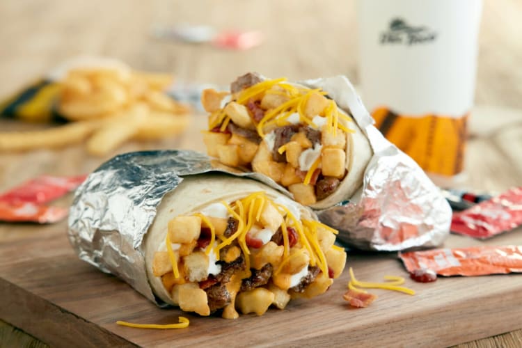 A burrito with fries inside