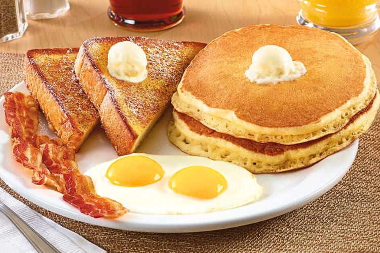 A breakfast from Denny’s with pancakes, eggs, bacon and French toast
