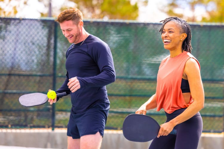 A couple playing pickleball