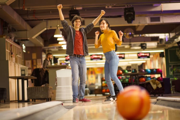 A couple bowling at a bowling alley
