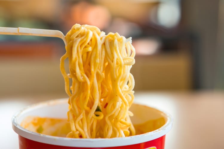 Ramen noodles being eaten from a cup