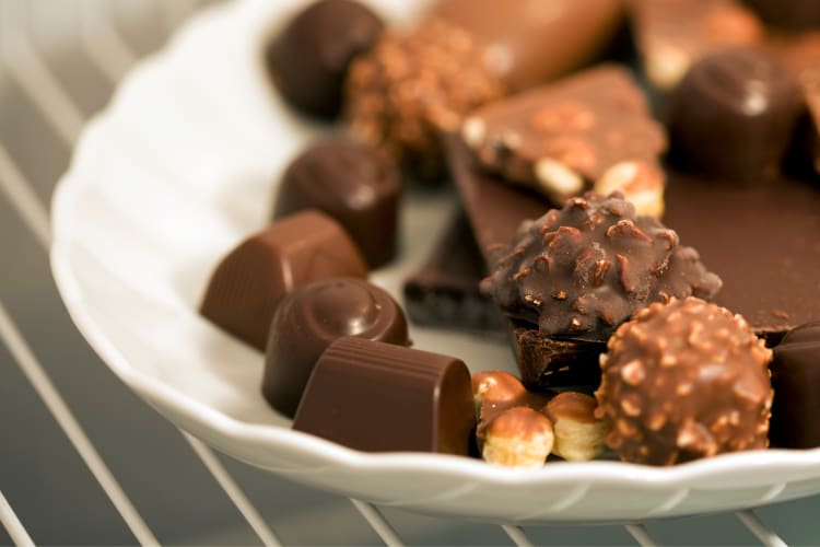 A plate of chocolates on a shelf in a fridge