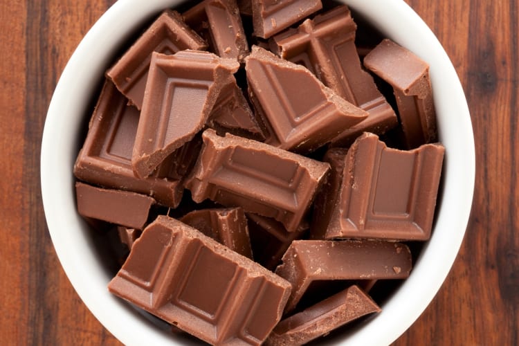 Squares of milk chocolate in a bowl