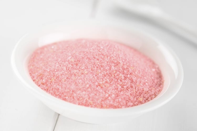 Red jello powder in a white bowl.