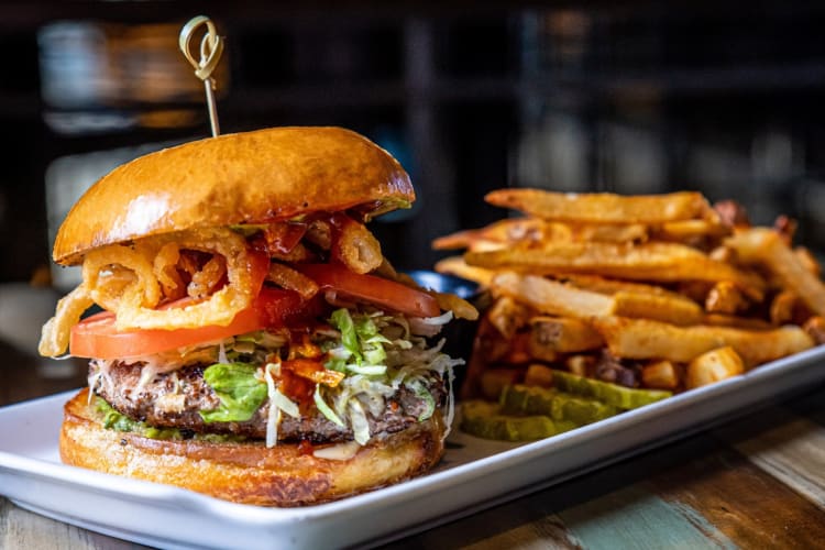 A burger and fries on a white plate