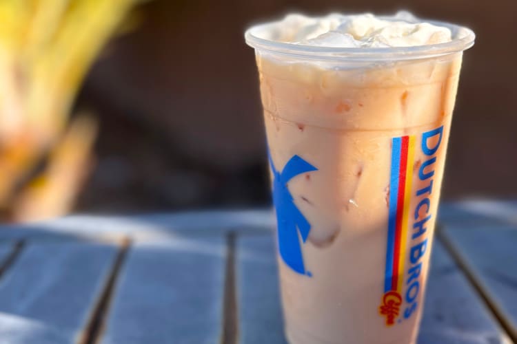 An iced chai drink with whipped cream