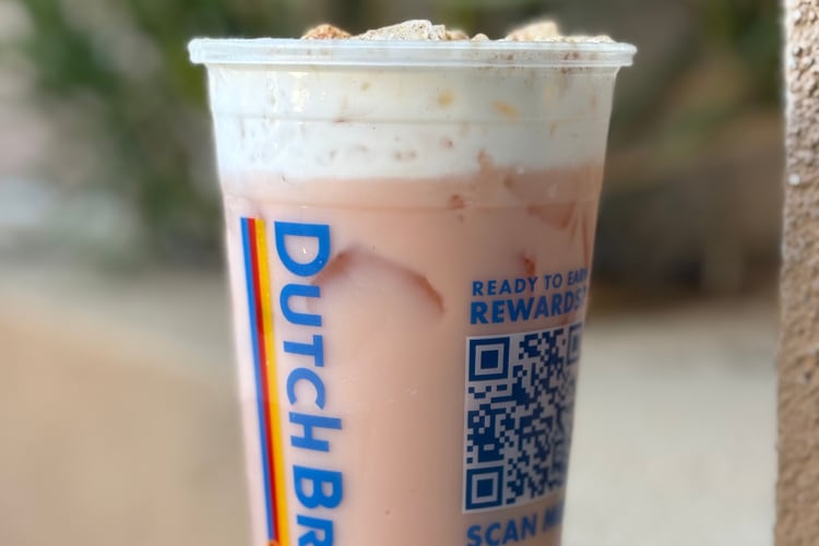 A Dutch Bros pink iced chai with whipped cream and cinnamon