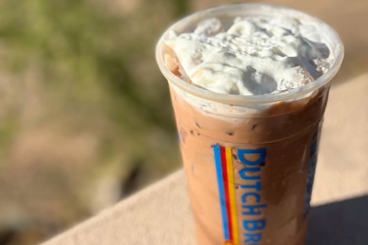 A Dutch Bros coffee topped with whipped cream