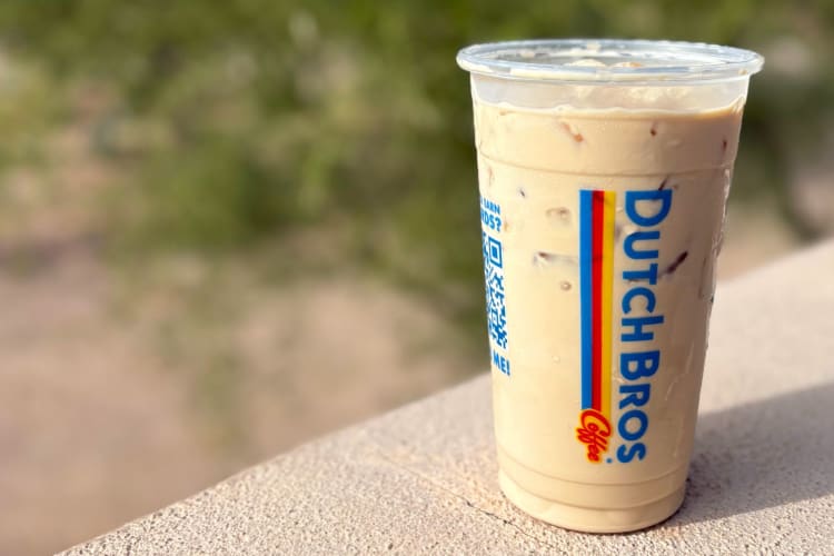 A milky coffee drink from Dutch Bros on a wall