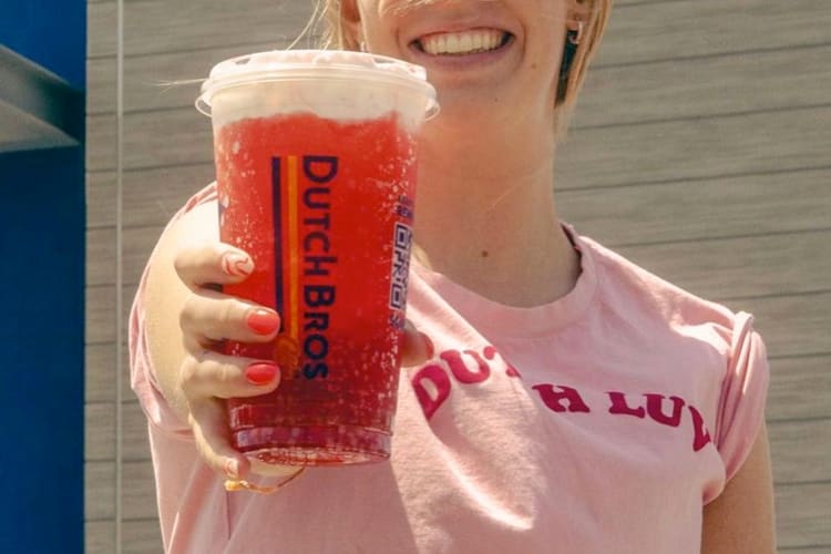 A person handing over a Dutch Bros secret menu drink
