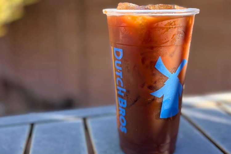 A clear Dutch Bros cup with a chocolate cold brew coffee