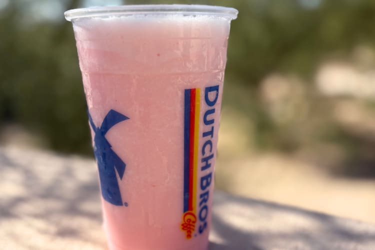 A pink drink in a clear Dutch Bros cup
