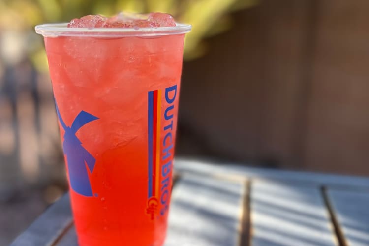 A red iced drink in a Dutch Bros cup