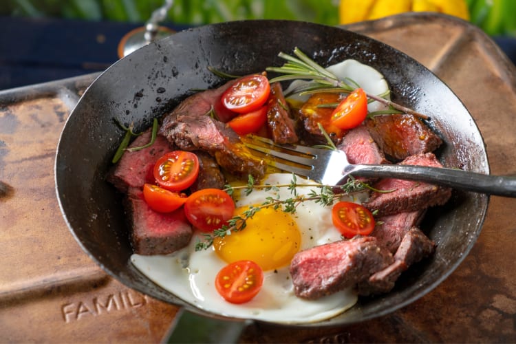 Steak and eggs breakfast served in a pan