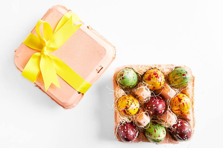 Colorful chocolate eggs in an egg carton